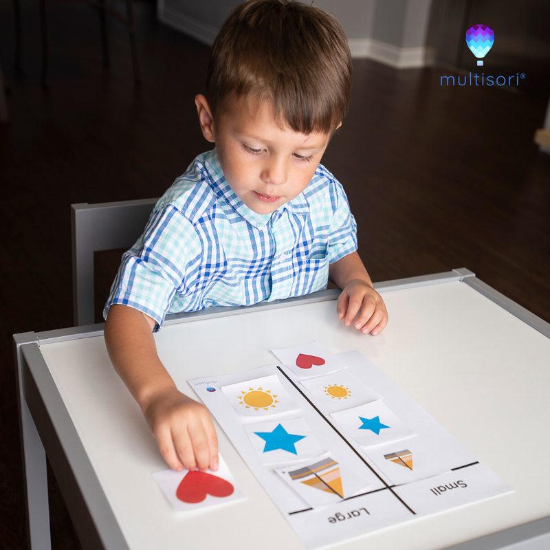 Toddler practices Montessori sorting small versus large measurement worksheet
