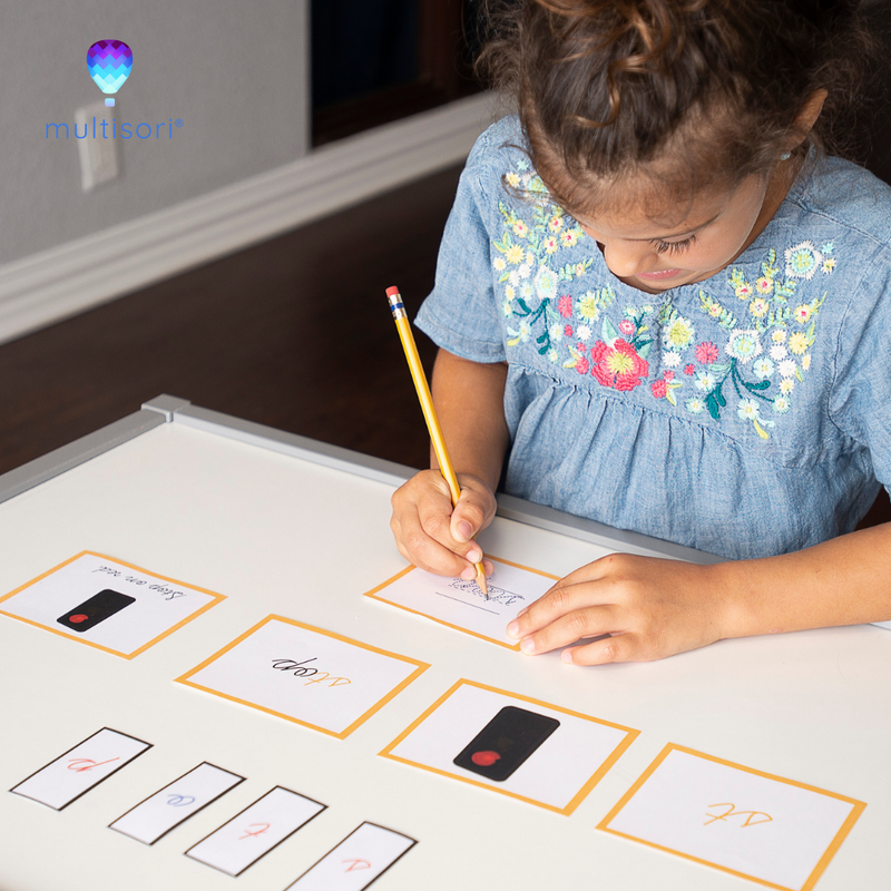 Young child practicing pincer grip and using printable tracing cards to practice writing skills and writing letters, example of Montessori sandpaper letters